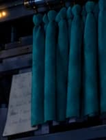 Teal curtain partly covering a pinned note