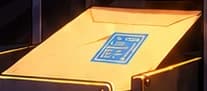 Cream envelope with blue approval mark in the input tray