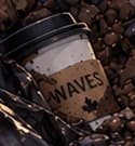 Discarded WAVES coffee cup among the landfill rubbish