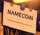 Namecoin slip pinned beneath the desk lamp