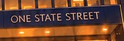 ONE STATE STREET sign above the warmly lit entrance