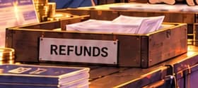 THE REFUND TRAY. The tray marked REFUNDS references the instruction for completed token offerings to make clearance and refund arrangements. Its envelopes are imagined props, not evidence from a particular project.