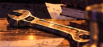THE MAINTENANCE WRENCH. The wrench at the lower right suggests ongoing risk management and parameter decisions. It is an artistic prop, not documented equipment. See the full illustration for this detail beneath the card's title area.