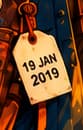 THE DATE TAG. The satchel's tag reads 19 JAN 2019, marking the experiment's start. It dates the historical event, not a documented meeting in this harbour.