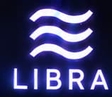 THE LIBRA EMBLEM. Three wave-like lines and the Libra name identify the proposed project on the plinth. The emblem anchors the scene to the 2019 announcement.