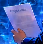 THE PROJECT PAPER. The observer holds a document marked Project Libra. It represents a proposal under consideration, rather than an operational currency or a facsimile of a historical document.