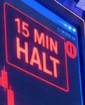 15 MIN HALT. The imagined cross-market monitor references the US equity circuit breaker. It does not claim that Bitcoin trading or its blockchain stopped for 15 minutes.