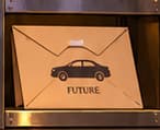 THE FUTURE CAR. The envelope marked FUTURE foreshadows Tesla's February 2021 disclosure. It is an intentional later reference, not evidence of a meeting, shared plan or historical envelope.