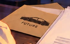 THE FUTURE ENVELOPE. A car silhouette on the FUTURE envelope echoes card 059. This cross-card clue sits beside the filing, linking the collection's visual stories without making a historical claim.