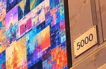 THE FIVE THOUSAND GRID. The 5000 plaque identifies the daily-work theme. The huge colour grid is newly invented imagery, not a copy of the auctioned collage or its individual pictures.
