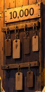 THE TEN THOUSAND TAGS. The 10,000 sign above the hanging tags points to the collection's fixed supply. The small rack is an illustrative shorthand for that total, not a literal inventory or a documented launch-day object.