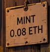 THE MINT PRICE. MINT 0.08 ETH records the original price to mint an ape. Ethereum transaction gas was an additional cost. The sign refers to the initial mint, not a later resale value.