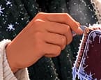 THE HAND AT THE ZIPPER. A small, familiar attempt to open a purse carries the story. The fictional woman represents frustration, not a particular depositor or a documented event.