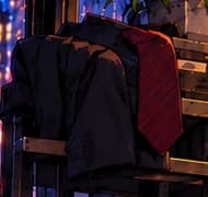 THE JACKET AND TIE. Office clothes hang behind the counter, close enough to suggest a trading desk has only recently given way to this new shift.