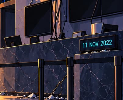A date among dark screens. The desk display reads 11 NOV 2022, anchoring the scene to the Chapter 11 filings. Blank screens suggest interrupted access and uncertainty, not a literal reconstruction of an FTX office.